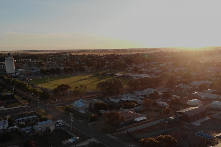 An aerial view of Australia city with river and bridges and buildings on a sunset