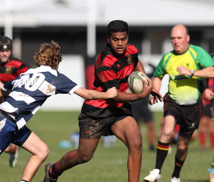 Adult and young men playing Rugby